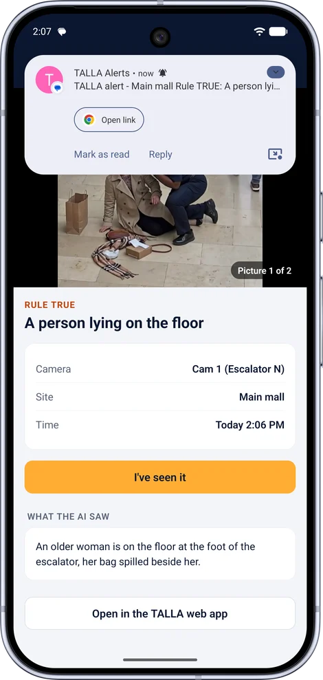 A TALLA alert on an Android phone: a person lying on the floor, with the camera, site and time, what the AI saw, and an I&rsquo;ve seen it button